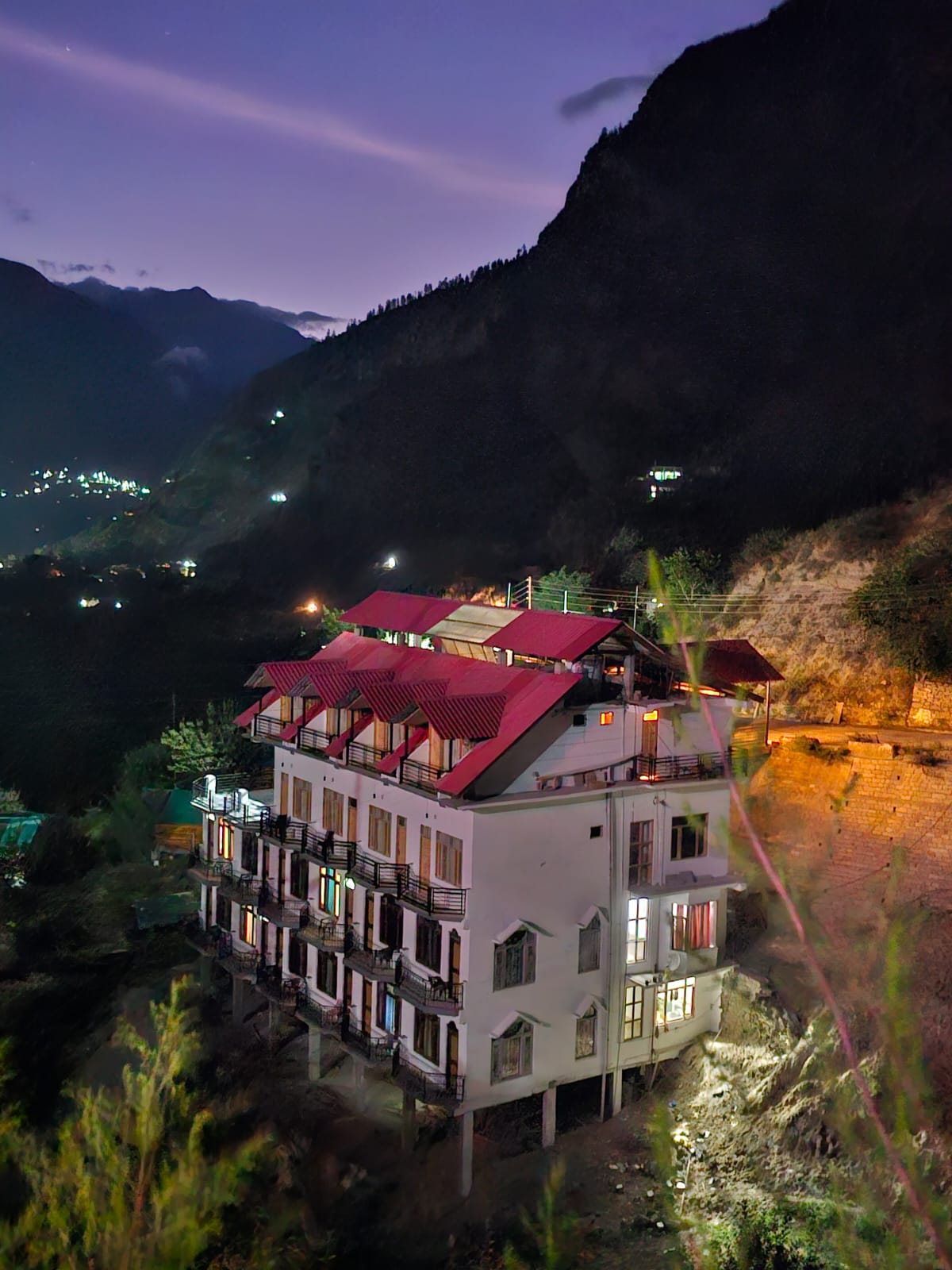 Hotel Apple Resort Sangla lit up at night